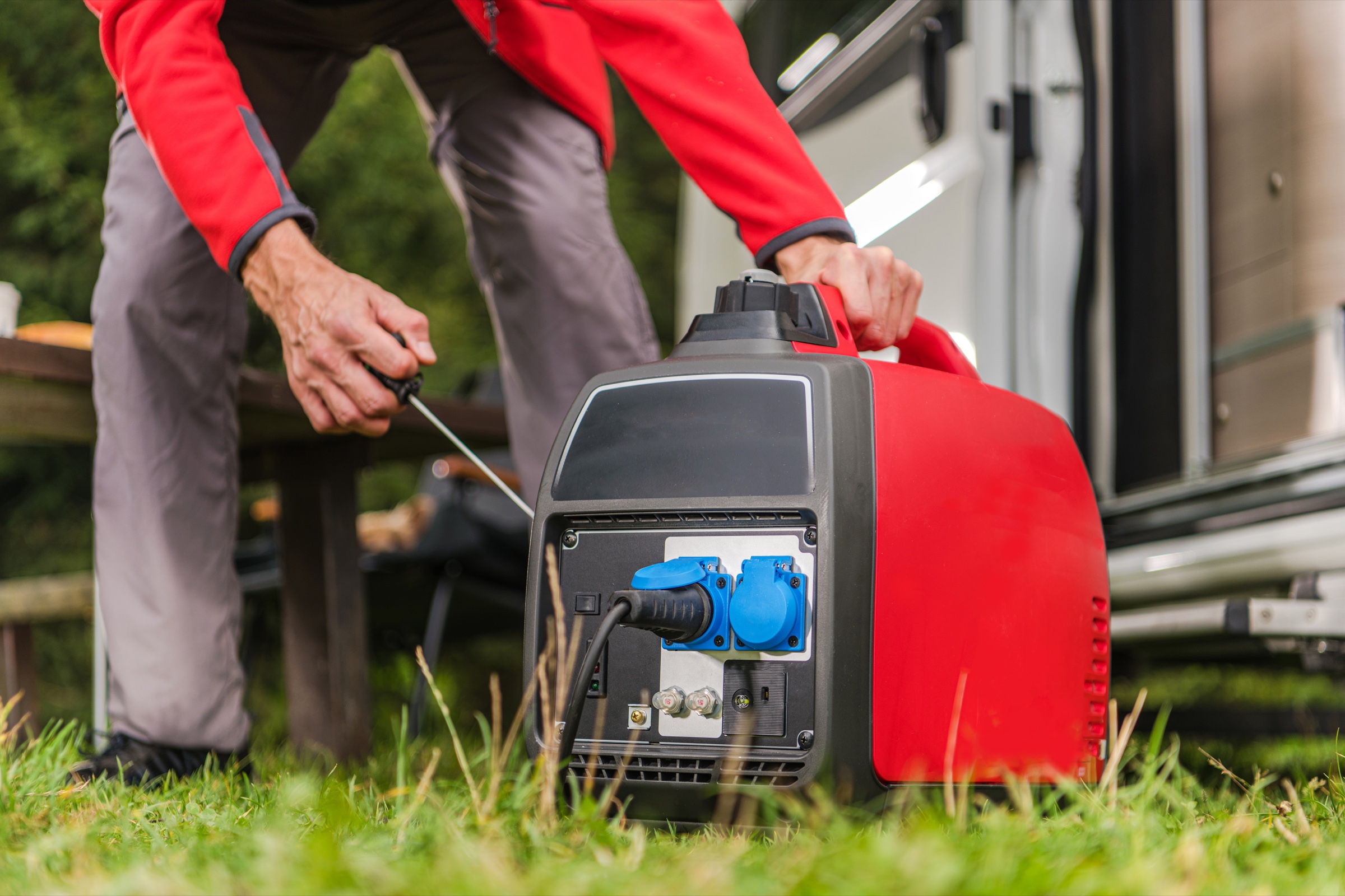 A compact generator used safely outdoors beside a camper