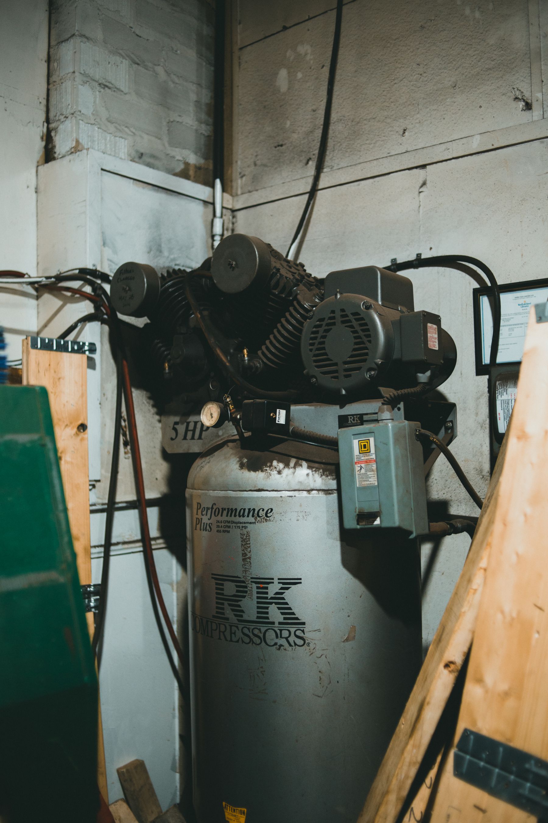 An electric workshop air compressor with motor, tank and pressure controls