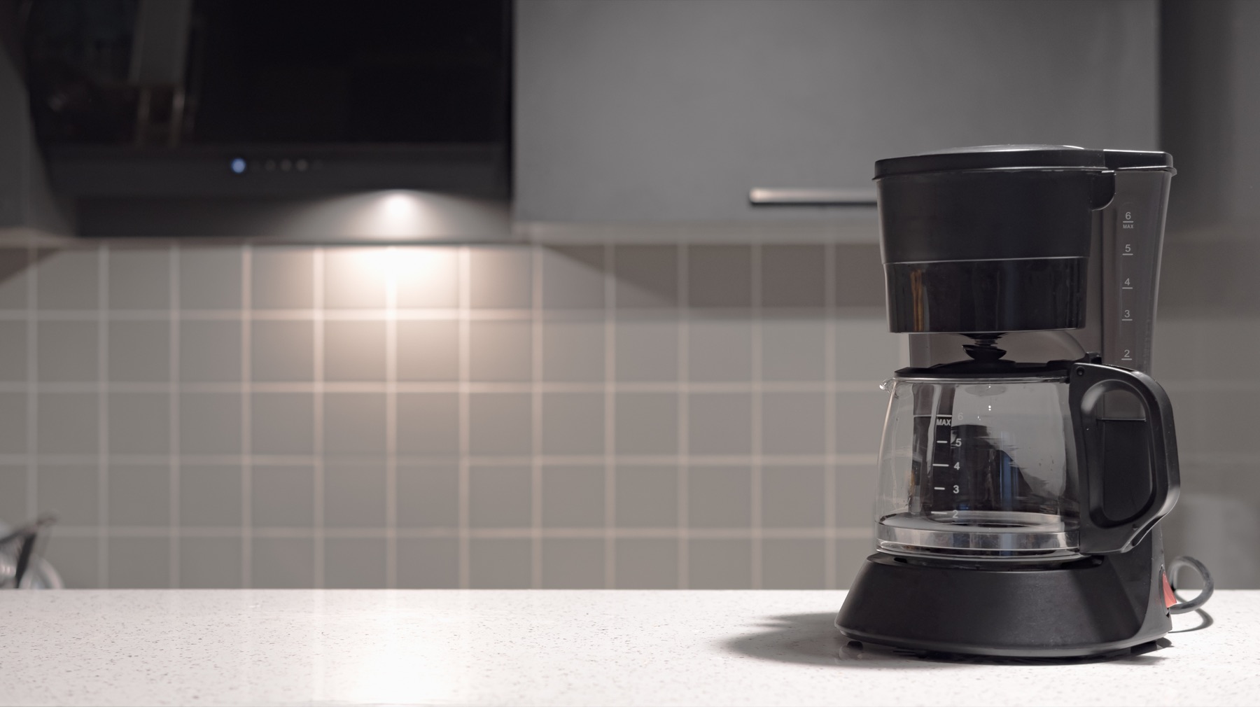 A drip coffee maker on a modern kitchen counter