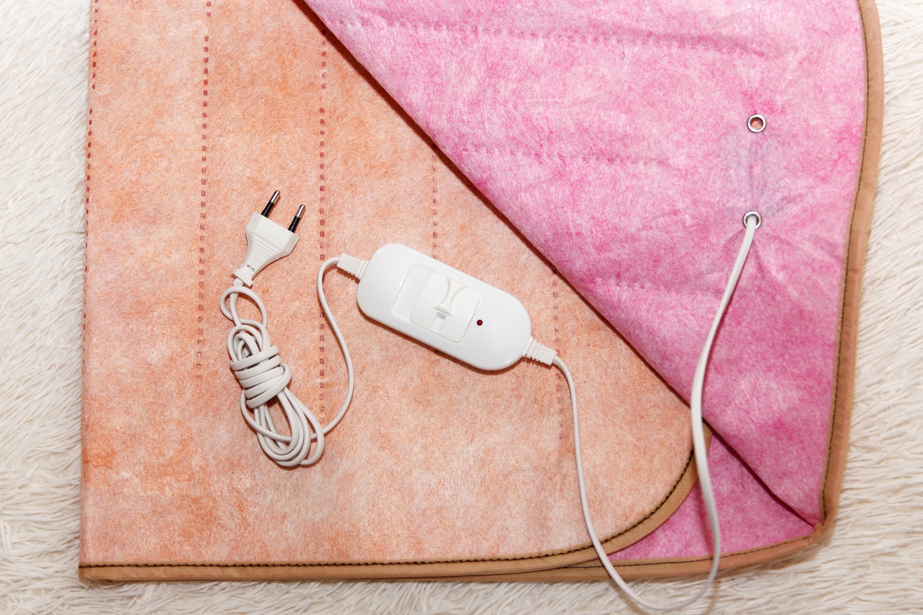 An electric heating blanket with its cord and controller