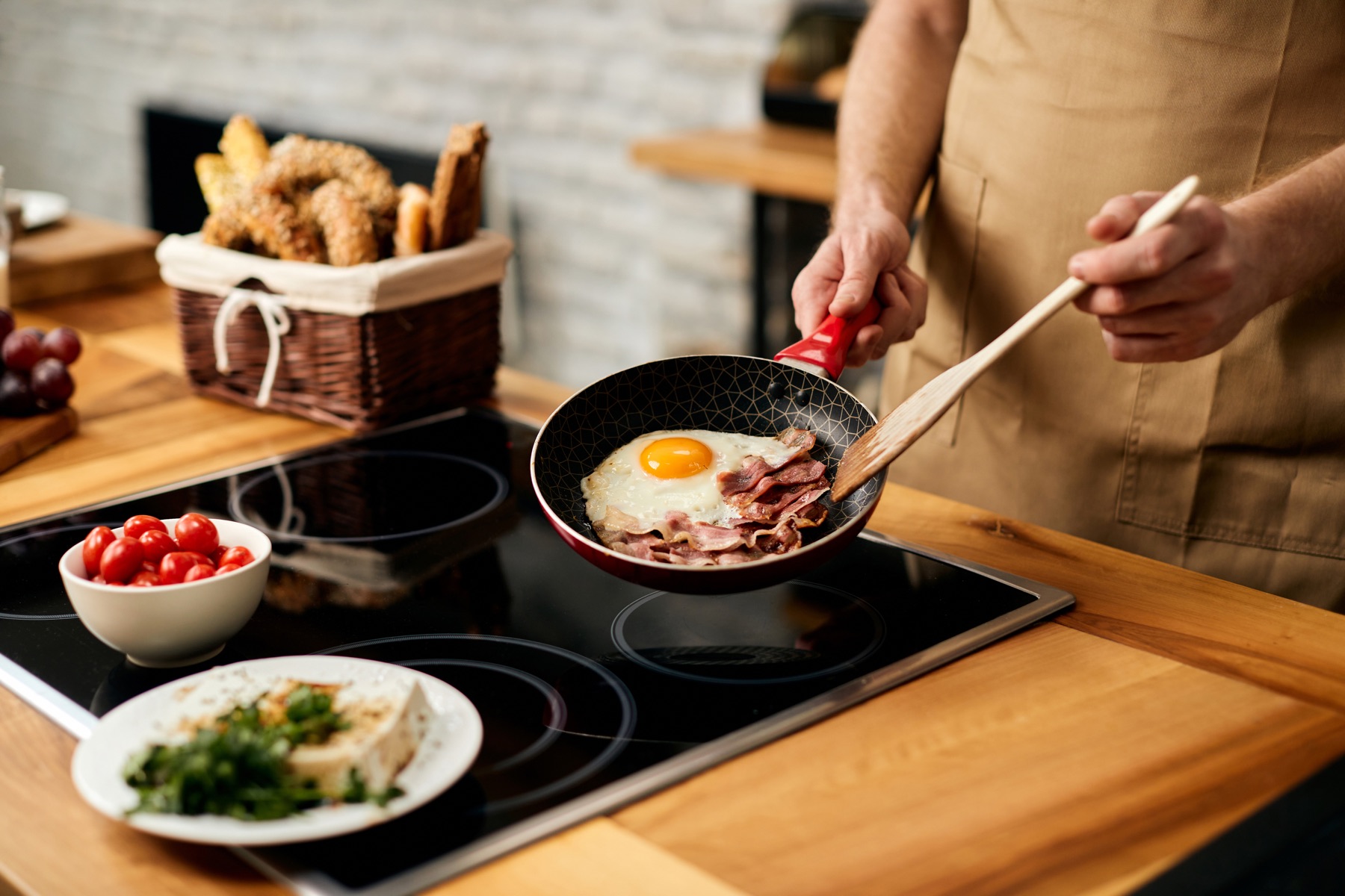 A person cooking eggs on an induction cooktop
