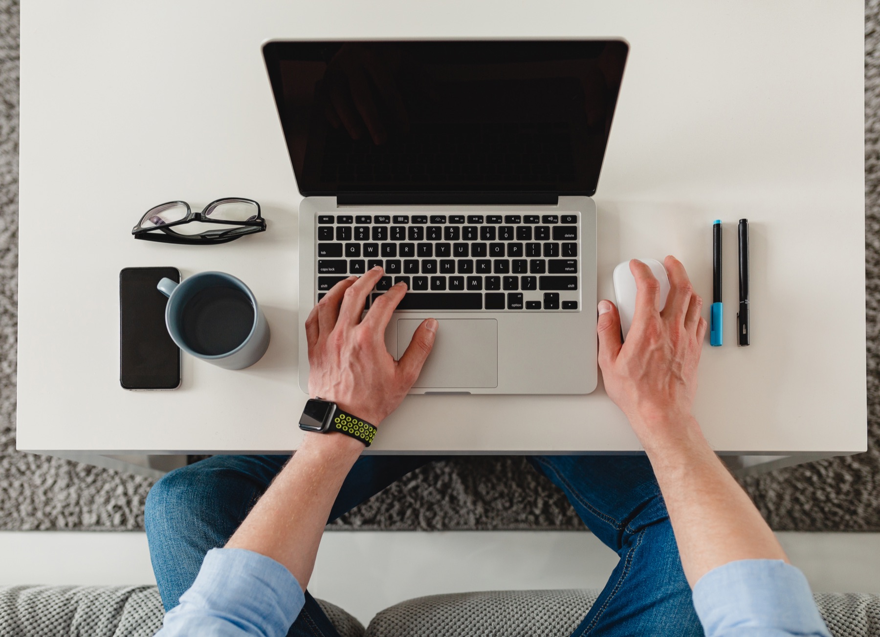 An overhead view of a person working on a laptop