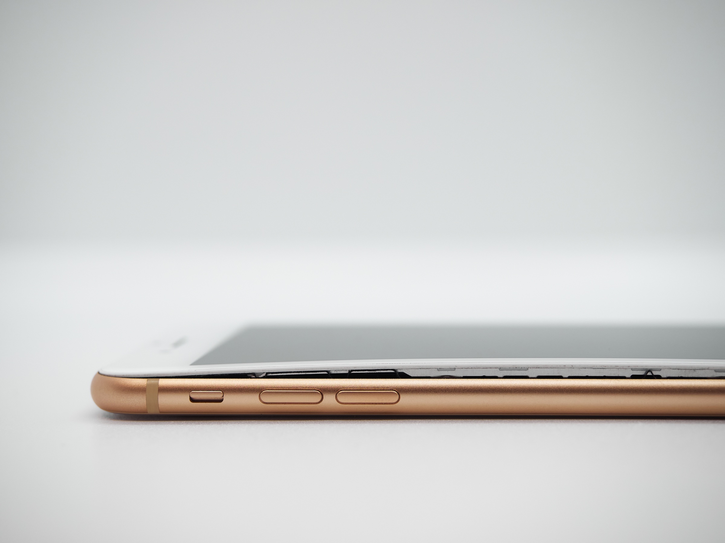 A smartphone screen pushed apart by a swollen lithium battery