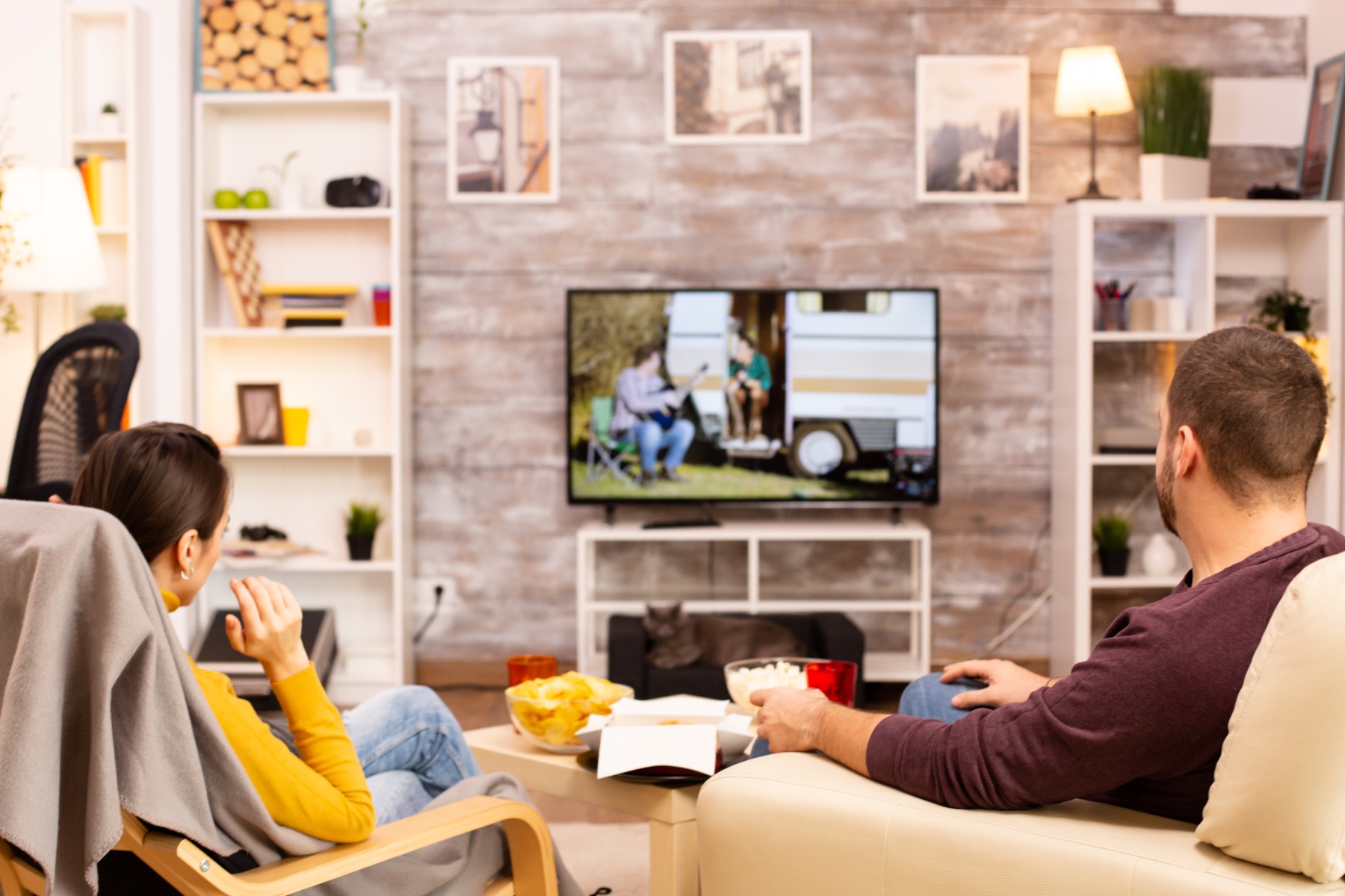Two people watching television in a living room