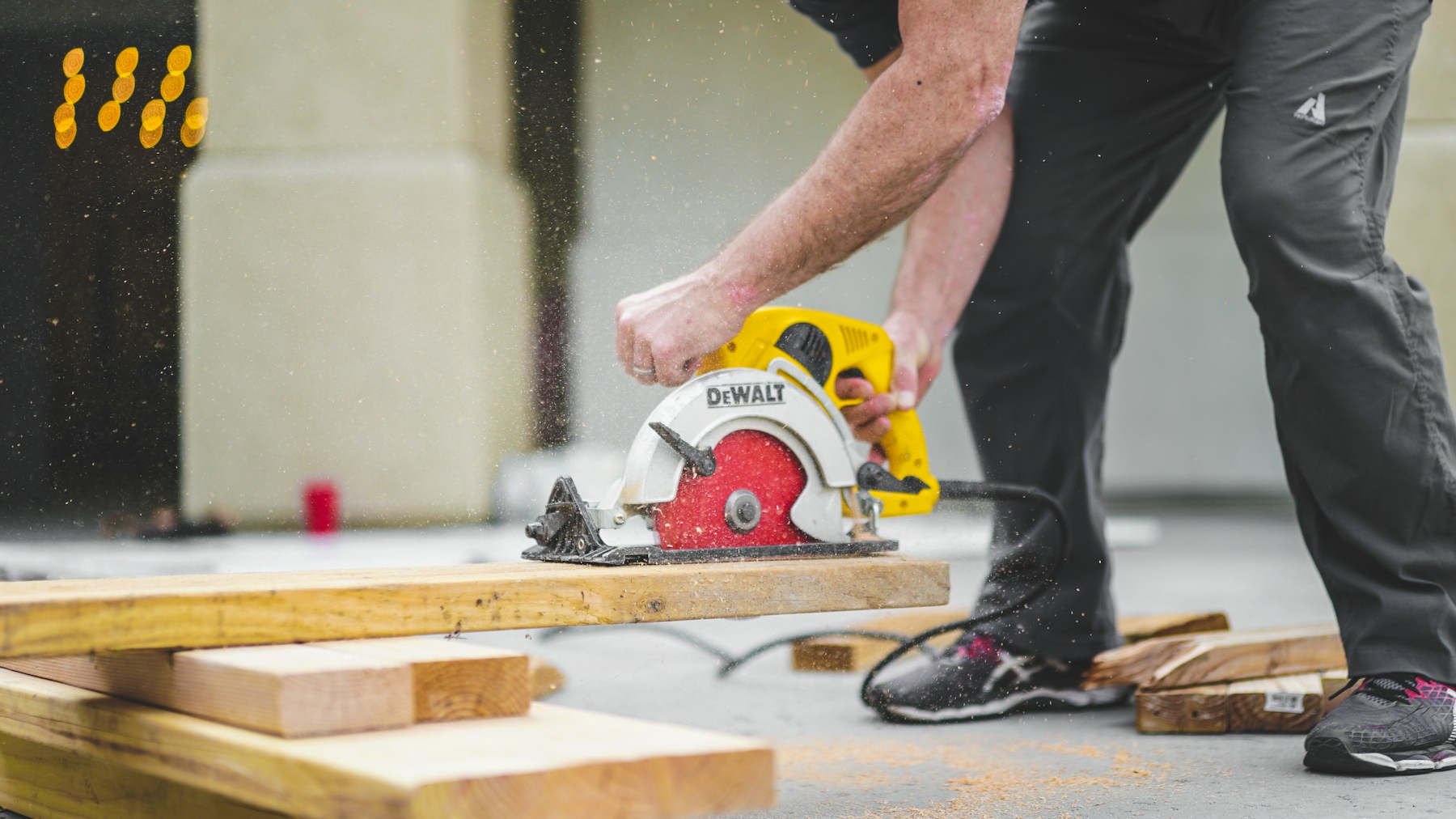 A worker using a guarded circular saw
